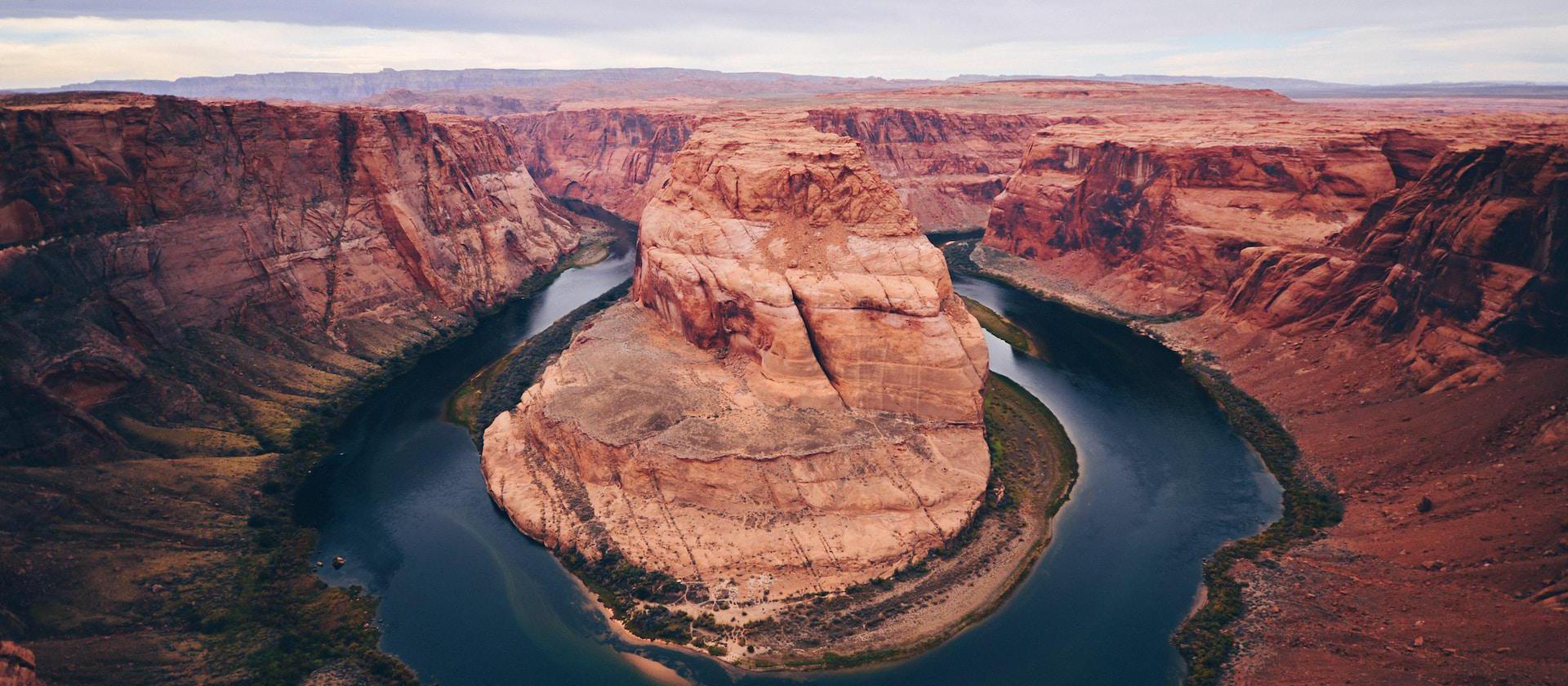 Image of horse shoe shaped river bending around a red rock.