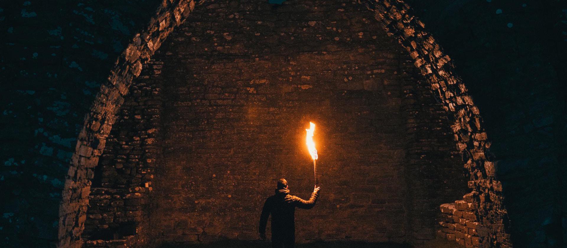 person holding torch in building interior