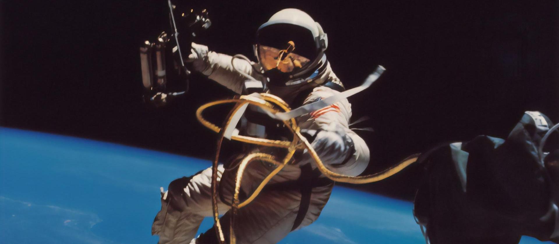 Image of a astronaut doing a space walk and what appears to be fixing things.