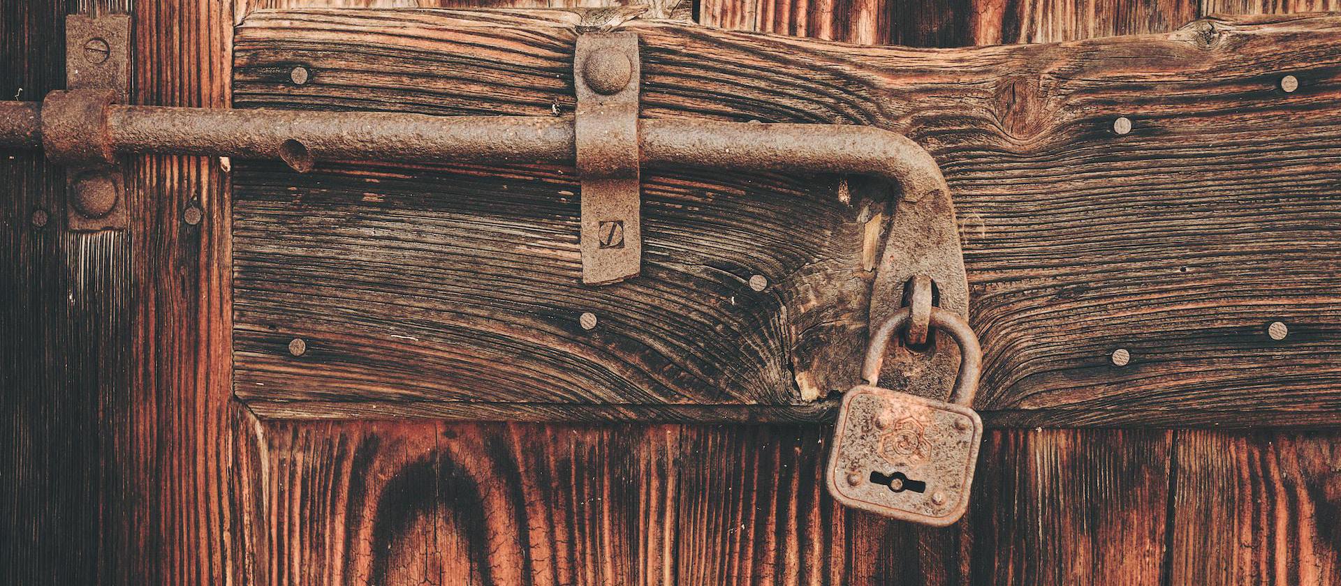 Rustic lock against wooden door.
